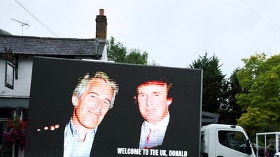 FILE PHOTO: An image of U.S. President Donald Trump alongside disgraced financier Jeffrey Epstein is displayed on a vehicle on the day of the state visit of the U.S. President and first lady Melania Trump, in Windsor, Britain, September 17, 2025. REUTERS/Phil Noble/File Photo (REUTERS)