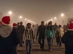 Gram it: Visitors at Kartavya Path walk amid a layer of smog as the entire sky above them appears engulfs in toxic air. Some weekend revellers add the much needed holiday cheer to the greys by flaunting red Santa caps! Delhi's AQI continues to remain 'very poor' as it stays above 300. Gram it: Visitors at Kartavya Path walk amid a layer of smog as the entire sky above them appears engulfs in toxic air. Some weekend revellers add the much needed holiday cheer to the greys by flaunting red Santa caps! Delhi's AQI continues to remain 'very poor' as it stays above 300.