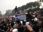 People gather around an ambulance carrying the body of leading Bangladeshi activist Sharif Osman Hadi, who died from gunshot wounds sustained in an attack in Dhaka People gather around an ambulance carrying the body of leading Bangladeshi activist Sharif Osman Hadi, who died from gunshot wounds sustained in an attack in Dhaka