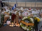 Candles are lit among floral tributes for victims and survivors of a deadly mass shooting during a Jewish Hanukkah celebration at Bondi Beach 