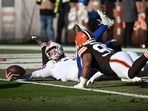Buffalo Bills quarterback Josh Allen is sacked by Cleveland Browns defensive tackle Mason Graham and defensive end Myles Garrett.