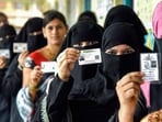 Maharashtra local body election results 2025 LIVE updates: Women show their identification cards as they wait to cast their votes in a queue at a polling booth during the Maharashtra local body elections, at Taloja, in Navi Mumbai, Tuesday, Dec. 2, 2025. 