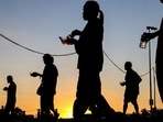 Displaced people walk after receiving food at a temporary shelter amid clashes between Thailand and Cambodia along a disputed border area, in Buriram province, Thailand, December 16, 2025.