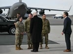 US President Donald Trump and US Secretary of Defense Pete Hegseth (R) greet members of the US military as they arrive at Dover Air Force Base in Delaware on December 17, 2025 . US President Donald Trump and US Secretary of Defense Pete Hegseth (R) greet members of the US military as they arrive at Dover Air Force Base in Delaware on December 17, 2025 .