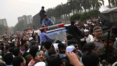 People gather around an ambulance carrying the body of leading Bangladeshi activist Sharif Osman Hadi, who died from gunshot wounds sustained in an attack in Dhaka (AP) People gather around an ambulance carrying the body of leading Bangladeshi activist Sharif Osman Hadi, who died from gunshot wounds sustained in an attack in Dhaka (AP)