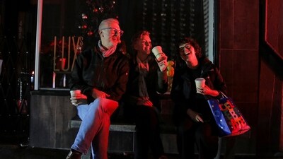 John Mleczko, left, and Julia Cooke, both of San Mateo, sit on a bench with their friend, Liz Norris, as they celebrate her birthday in the dark after a major power outage in San Francisco, Saturday, Dec. 20, 2025. (Yalonda M. James/San Francisco Chronicle via AP) (AP) John Mleczko, left, and Julia Cooke, both of San Mateo, sit on a bench with their friend, Liz Norris, as they celebrate her birthday in the dark after a major power outage in San Francisco, Saturday, Dec. 20, 2025. (Yalonda M. James/San Francisco Chronicle via AP) (AP)