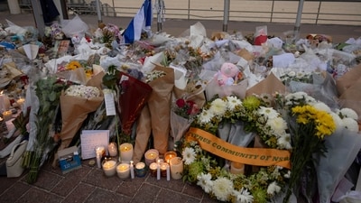 Candles are lit among floral tributes for victims and survivors of a deadly mass shooting during a Jewish Hanukkah celebration at Bondi Beach (Reuters)