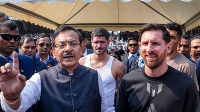 Argentine footballer Lionel Messi with West Bengal Sports Minister Aroop Biswas during an event as part of his 'G.O.A.T. India Tour 2025' in Kolkata on December 13. (PTI)