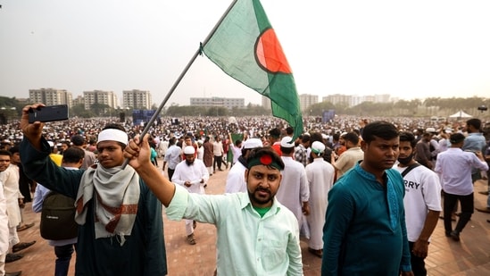 Mourners were seen with Bangladesh's national flag during the funeral of student leader Sharif Osman Hadi in Dhaka on December 20. (AFP)