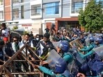 Bangladeshi police try to stop demonstrators as they march towards the assistant Indian high commissioner office in Rajshahi.