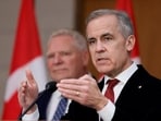 Canada's Prime Minister Mark Carney (right) and Ontario’s Premier Doug Ford take part in a press conference on Parliament Hill in Ottawa, Ontario, on December 18. (REUTERS)