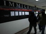 Masked federal agents walk in a hallway at the New York Federal Plaza Immigration Court inside the Jacob K. Javitz Federal Building in New York.