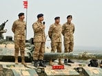 File photo: Chief of Army Staff of Pakistan Asim Munir holds a microphone during his visit at the Tilla Field Firing Ranges (TFFR) 