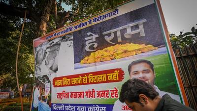 A poster opposing the renaming of the MGNREGA scheme at Raisina Road in New Delhi. (HT Photo/Sanchit Khanna)