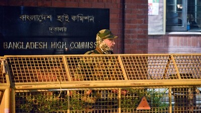 A security official stands guard outside the Bangladesh High Commission following protests in Bangladesh after the death of leader Sharif Osman Hadi, in New Delhi. (Photo for representation) (ANI) A security official stands guard outside the Bangladesh High Commission following protests in Bangladesh after the death of leader Sharif Osman Hadi, in New Delhi. (Photo for representation) (ANI)