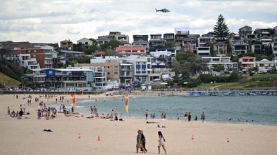A police helicopter patrols over the Bondi Beach a week after the the shooting attack in Sydney. (AFP) A police helicopter patrols over the Bondi Beach a week after the the shooting attack in Sydney. (AFP)