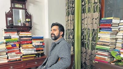 The living room is full of family photos and showpiece knickknacks. But it is primarily crammed with books. (Mayank Austen Soofi) The living room is full of family photos and showpiece knickknacks. But it is primarily crammed with books. (Mayank Austen Soofi)