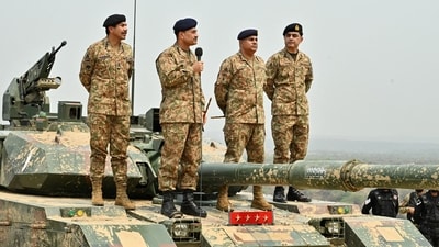 File photo: Chief of Army Staff of Pakistan Asim Munir holds a microphone during his visit at the Tilla Field Firing Ranges (TFFR) (via REUTERS)