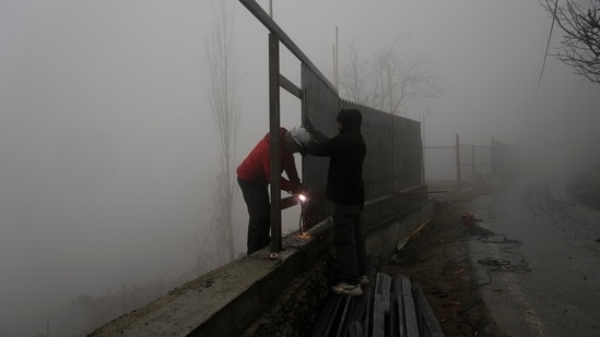 Today weather live updates: Welders work amid dense fog as it rains on the outskirts of Srinagar, Kashmir on Sunday, Dec. 21, 2025. Today weather live updates: Welders work amid dense fog as it rains on the outskirts of Srinagar, Kashmir on Sunday, Dec. 21, 2025.