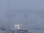 Vehicles commute through the Barapullah flyover area covered with smog. 