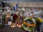 Candles are lit among floral tributes for victims and survivors of a deadly mass shooting during a Jewish Hanukkah celebration at Bondi Beach.