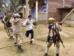 Security personnel lathi-charge people during a clash between two groups over the issue of eviction, at Kheroni in West Karbi Anglong district, Assam.