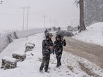 People during a fresh spell of snowfall, in Gulmarg on Monday. (ANI)