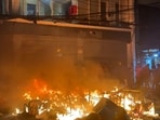 Smashed windows and a fire outside the Prothom Alo office in Dhaka, amid protests following the news of the death of youth leader Osman Hadi.