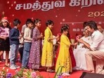 Tamilaga Vettri Kazhagam (TVK) chief Vijay receives flowers from children during an 'Equality Christmas' celebration, in Mamallapuram, Tamil Nadu on Monday. (PTI) Tamilaga Vettri Kazhagam (TVK) chief Vijay receives flowers from children during an 'Equality Christmas' celebration, in Mamallapuram, Tamil Nadu on Monday. (PTI)