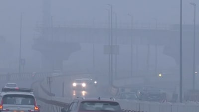 Vehicles commute through the Barapullah flyover area covered with smog. (ANI Video Grab) Vehicles commute through the Barapullah flyover area covered with smog. (ANI Video Grab)