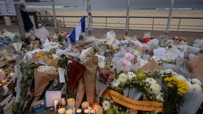 Candles are lit among floral tributes for victims and survivors of a deadly mass shooting during a Jewish Hanukkah celebration at Bondi Beach. (Reuters)