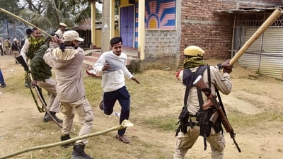 Security personnel lathi-charge people during a clash between two groups over the issue of eviction, at Kheroni in West Karbi Anglong district, Assam. (PTI) Security personnel lathi-charge people during a clash between two groups over the issue of eviction, at Kheroni in West Karbi Anglong district, Assam. (PTI)