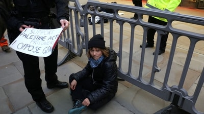 A handout photograph taken on and released by Prisoners for Palestine in London on December 23, 2025 shows Swedish activist Greta Thunberg before her arrest by Police officers outside the offices of Aspen Insurance at Plantation Place on Fenchurch Street. London police on Tuesday arrested Swedish activist Greta Thunberg at a demonstration in support of pro-Palestinian hunger strikers, Palestinian activist groups said. "Greta Thunberg was arrested under the Terrorism Act at the Prisoners for Palestine lock-on protest," Prisoners for Palestine said in a statement. (AFP) A handout photograph taken on and released by Prisoners for Palestine in London on December 23, 2025 shows Swedish activist Greta Thunberg before her arrest by Police officers outside the offices of Aspen Insurance at Plantation Place on Fenchurch Street. London police on Tuesday arrested Swedish activist Greta Thunberg at a demonstration in support of pro-Palestinian hunger strikers, Palestinian activist groups said. "Greta Thunberg was arrested under the Terrorism Act at the Prisoners for Palestine lock-on protest," Prisoners for Palestine said in a statement. (AFP)
