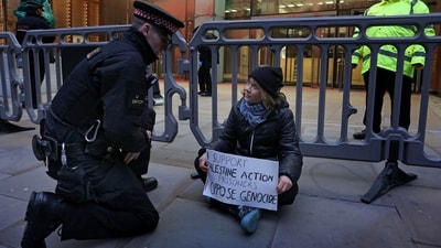 A handout photograph taken on and released by Prisoners for Palestine in London on December 23, 2025 shows Swedish activist Greta Thunberg before her arrest by Police officers outside the offices of Aspen Insurance at Plantation Place on Fenchurch Street. London police on Tuesday arrested Swedish activist Greta Thunberg at a demonstration in support of pro-Palestinian hunger strikers, Palestinian activist groups said. "Greta Thunberg was arrested under the Terrorism Act at the Prisoners for Palestine lock-on protest," Prisoners for Palestine said in a statement. (AFP) A handout photograph taken on and released by Prisoners for Palestine in London on December 23, 2025 shows Swedish activist Greta Thunberg before her arrest by Police officers outside the offices of Aspen Insurance at Plantation Place on Fenchurch Street. London police on Tuesday arrested Swedish activist Greta Thunberg at a demonstration in support of pro-Palestinian hunger strikers, Palestinian activist groups said. "Greta Thunberg was arrested under the Terrorism Act at the Prisoners for Palestine lock-on protest," Prisoners for Palestine said in a statement. (AFP)