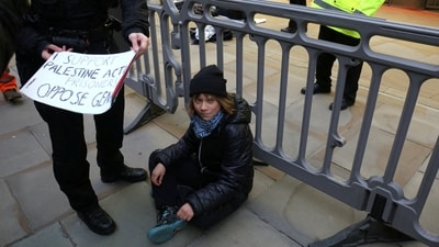 A police officer takes away a sign that Swedish activist Greta Thunberg was holding during a pro-Palestinian protest that says she supports prisoners linked to Palestine Action, an organisation which the British government has proscribed as a terrorist group, in London, Britain, December 23, 2025. (via REUTERS)