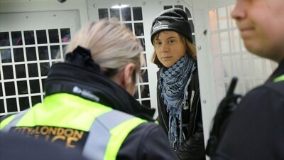 Swedish activist Greta Thunberg sits inside a police van, according to solicitors acting on her behalf, as she was arrested at a pro-Palestinian protest for holding a sign that said she supported prisoners linked to Palestine Action, an organisation which the British government has proscribed as a terrorist group, in London, Britain, December 23, 2025.&nbsp; (via REUTERS)