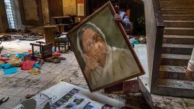 An employee arranges the vandalised office of the Chhayanaut in Dhaka after it was vandalised amid protest in Bangladesh (AFP) An employee arranges the vandalised office of the Chhayanaut in Dhaka after it was vandalised amid protest in Bangladesh (AFP)