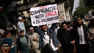 A protester holds a placard and shout slogans during a protest following overnight attacks and vandalism after the death of a prominent activist in Bangladesh (AP) A protester holds a placard and shout slogans during a protest following overnight attacks and vandalism after the death of a prominent activist in Bangladesh (AP)