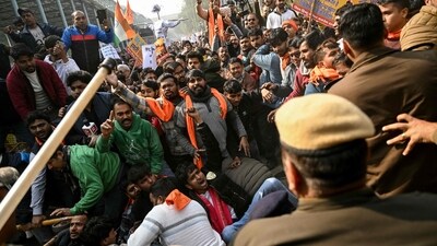 Security personnel try to stop Vishva Hindu Parishad (VHP) activists along with others during a protest march near the Bangladesh High Commission in New Delhi on Tuesday (AFP)