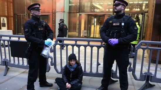 A police officer takes away a sign that Swedish activist Greta Thunberg was holding during a pro-Palestinian protest that says she supports prisoners linked to Palestine Action, an organisation which the British government has proscribed as a terrorist group, in London, Britain, December 23, 2025.&nbsp;(via REUTERS)
