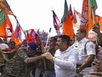 Howrah: Security personnel try to stop BJP supporters during a protest against the alleged killing of a Hindu youth in Bangladesh, near Howrah Bridge (PTI)