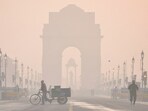 New Delhi: The India Gate shrouded in a layer of smog as people make their way during a cold winter morning, at Kartavya Path, in New Delhi.