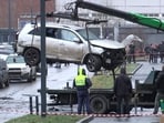 A crane loads a car onto a platform at the scene where Lt. Gen. Fanil Sarvarov was killed by an explosive device placed under his car in Moscow.