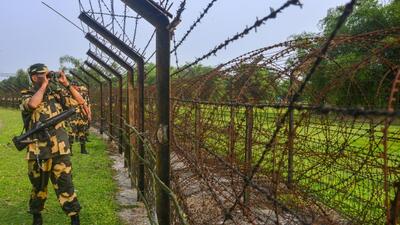 Border Security Force (BSF) personnel stand guard along the India-Bangladesh border on the outskirts of Siliguri, (PTI FILE/Representative Image) Border Security Force (BSF) personnel stand guard along the India-Bangladesh border on the outskirts of Siliguri, (PTI FILE/Representative Image)