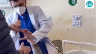 In a screenshot from a viral video, a doctor is seen assaulting a patient, who was lying on a bed in the hospital, after an argument, at Indira Gandhi Medical College (IGMC), in Shimla on Monday. (PTI) In a screenshot from a viral video, a doctor is seen assaulting a patient, who was lying on a bed in the hospital, after an argument, at Indira Gandhi Medical College (IGMC), in Shimla on Monday. (PTI)