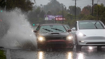 A car drives through a flooded road on La Cienega Boulevard on December 24, 2025 in Los Angeles, California. (AFP) A car drives through a flooded road on La Cienega Boulevard on December 24, 2025 in Los Angeles, California. (AFP)