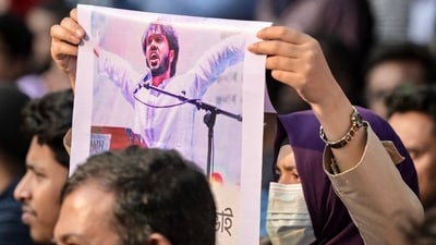 An activist holds a poster of Sharif Osman Hadi, senior leader of the student protest group Inqilab Moncho, who was shot outside a mosque in Dhaka (AFP/File) An activist holds a poster of Sharif Osman Hadi, senior leader of the student protest group Inqilab Moncho, who was shot outside a mosque in Dhaka (AFP/File)