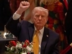 President Donald Trump pumps his fist at Christmas Eve dinner at his Mar-a-Lago club, Wednesday. President Donald Trump pumps his fist at Christmas Eve dinner at his Mar-a-Lago club, Wednesday.