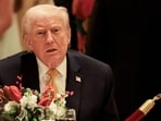 US President Donald Trump takes part in a Christmas Eve dinner in the ballroom of his Mar-a-Lago club in Palm Beach, Florida. 