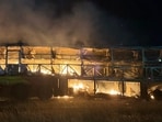 The impact caused the sleeper coach to catch fire in the middle of the highway, trapping several passengers inside.